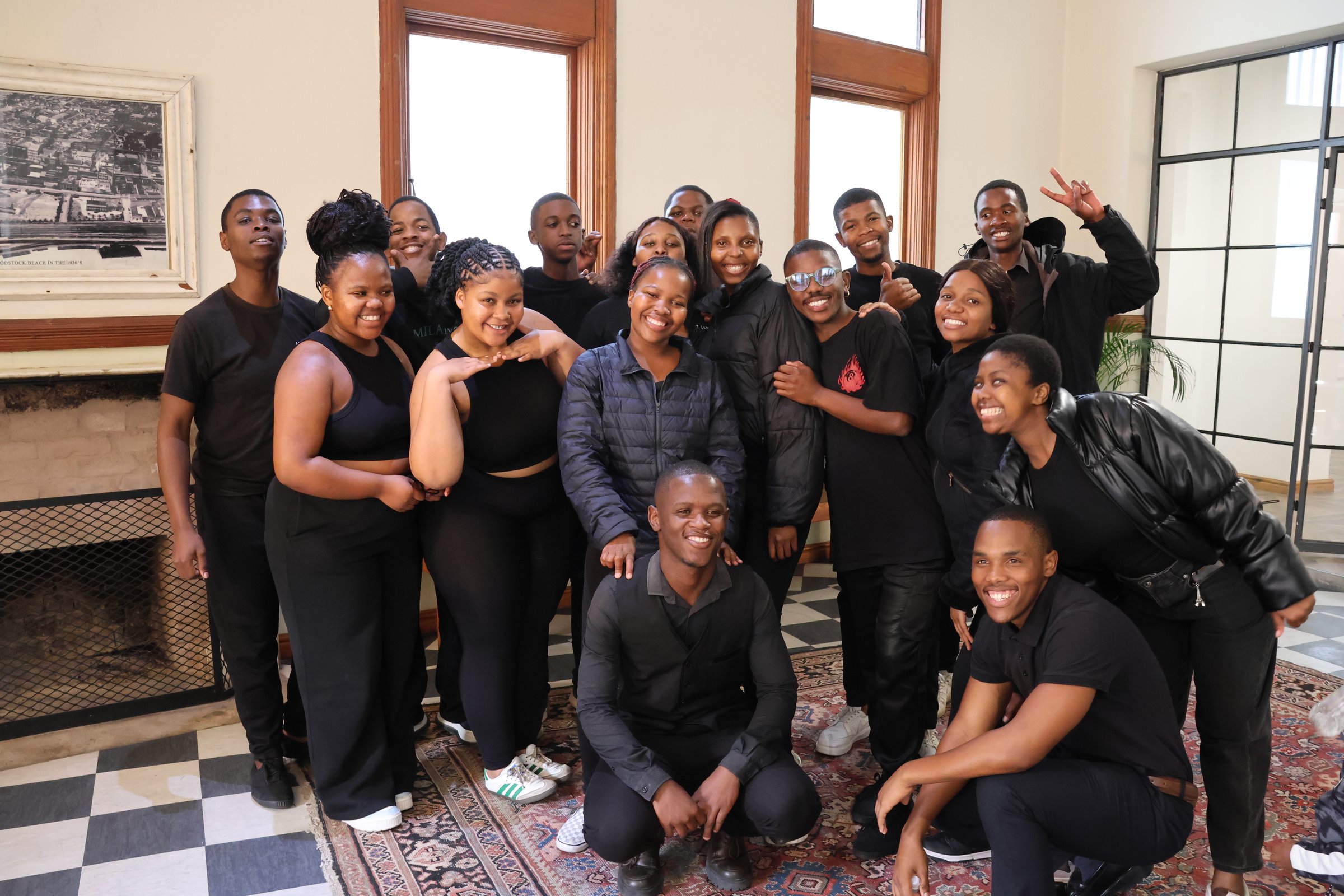 The sixteen founding members of Lizwi Choir, photographed together at 196 Victoria, Cape Town.