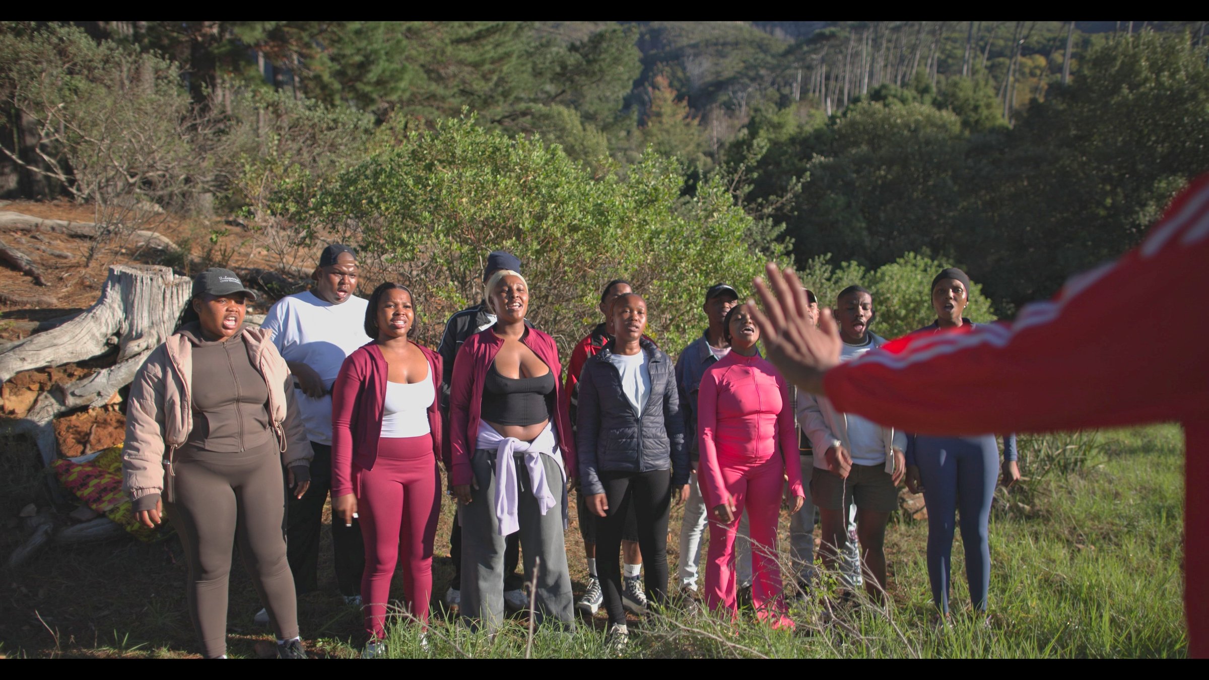 Lizwi Choir singing in Newlands Forest, Cape Town, with our musical director Prince Maqhajana leading.